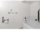 White bathroom features white walls, a white bathtub, and chrome fixtures at 7319 E Northland Dr # 5, Scottsdale, AZ 85251