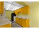 Bright kitchen features yellow cabinetry, black refrigerator, white dishwasher, and a neutral countertop at 7319 E Northland Dr # 5, Scottsdale, AZ 85251