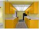 Galley kitchen with yellow cabinetry and appliances, featuring a tile floor at 7319 E Northland Dr # 5, Scottsdale, AZ 85251