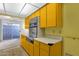 Bright yellow kitchen featuring vintage cabinetry and modern appliances at 7319 E Northland Dr # 5, Scottsdale, AZ 85251