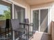 Relaxing balcony with a table, chairs, and double sliding glass doors at 7474 E Earll Dr # 311, Scottsdale, AZ 85251