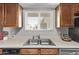 Well-lit kitchen area with a stainless steel sink and cabinets at 7474 E Earll Dr # 311, Scottsdale, AZ 85251