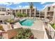 Resort-style community pool surrounded by lounge chairs and lush landscaping at 7474 E Earll Dr # 311, Scottsdale, AZ 85251