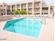 Inviting community pool with lounge chairs, tables, and well maintained apartment buildings at 7474 E Earll Dr # 311, Scottsdale, AZ 85251