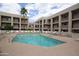 Community pool and deck with ample lounging chairs at 7474 E Earll Dr # 311, Scottsdale, AZ 85251