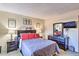 The bedroom has a dresser, mirror, wall-mounted TV and coordinated decorations at 7625 E Camelback Rd # A249, Scottsdale, AZ 85251