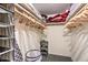 Walk-in closet with shelving, wooden hangers, and a clothing organizer at 7625 E Camelback Rd # A249, Scottsdale, AZ 85251