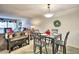 A simple dining area with a square table, chairs, and a decorative wreath, connected to the living room at 7625 E Camelback Rd # A249, Scottsdale, AZ 85251