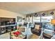 Relaxing living room with a plush armchair, entertainment center, and glass table with a balcony view at 7625 E Camelback Rd # A249, Scottsdale, AZ 85251