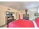 Well-lit bedroom featuring a comfortable bed with a red quilt and complementing furniture at 7625 E Camelback Rd # A249, Scottsdale, AZ 85251