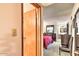 View from a doorway into a bedroom with a red comforter, furniture, and bathroom at 7625 E Camelback Rd # A249, Scottsdale, AZ 85251