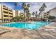 Enjoy the community pool surrounded by lounge chairs, palm trees and well maintained exterior of residential units at 7625 E Camelback Rd # A249, Scottsdale, AZ 85251