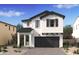 Charming two-story home with a modern farmhouse design and a welcoming front entrance at 8006 W Griswold Rd, Peoria, AZ 85345