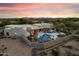 Stunning aerial view of the private desert oasis featuring custom pool, mountain views and desert landscaping at 9022 E Diamond Rim Dr, Scottsdale, AZ 85255