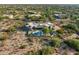 Expansive aerial view of the property showcasing the pool, outdoor living spaces, and desert surroundings at 9022 E Diamond Rim Dr, Scottsdale, AZ 85255