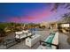 Beautiful backyard featuring a pool, desert landscaping and outdoor seating around a modern fire pit at 9022 E Diamond Rim Dr, Scottsdale, AZ 85255
