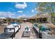 Expansive outdoor living space with modern seating, lush landscaping, and a beautiful pool view at 9022 E Diamond Rim Dr, Scottsdale, AZ 85255