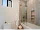 Modern bathroom featuring a shower and bath combination with custom tile, storage, and glass door at 9022 E Diamond Rim Dr, Scottsdale, AZ 85255