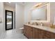 Luxurious bathroom featuring double sinks, marble countertops, and modern fixtures with outdoor access at 9022 E Diamond Rim Dr, Scottsdale, AZ 85255