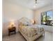 Cozy bedroom with a decorative bed, side tables, and serene views from the bright window at 9022 E Diamond Rim Dr, Scottsdale, AZ 85255