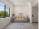 Cozy bedroom with a large window offering natural light, a comfortable sofa, and stylish decor at 9022 E Diamond Rim Dr, Scottsdale, AZ 85255