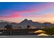 Mountainous city views with city lights viewed from rooftop deck at sunset at 9022 E Diamond Rim Dr, Scottsdale, AZ 85255