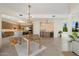 Open dining and kitchen area with modern lighting, breakfast bar, and seamless flow for entertaining at 9022 E Diamond Rim Dr, Scottsdale, AZ 85255