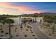 Expansive desert home with neutral tones, desert landscaping, and mountain views at sunset at 9022 E Diamond Rim Dr, Scottsdale, AZ 85255