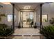 Covered front entrance with desert landscaping and views into the house with fireplace at 9022 E Diamond Rim Dr, Scottsdale, AZ 85255