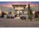 Front exterior of desert home featuring large cacti, brick driveway and desert landscape design at 9022 E Diamond Rim Dr, Scottsdale, AZ 85255