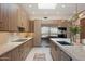 Bright kitchen featuring stainless steel appliances, stylish countertops, and modern wood cabinets at 9022 E Diamond Rim Dr, Scottsdale, AZ 85255