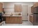 Well-lit laundry room featuring modern cabinetry, sleek countertops, and stainless steel appliances for efficient chores at 9022 E Diamond Rim Dr, Scottsdale, AZ 85255