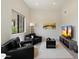 Bright living room with black armchairs, a TV, and a large window providing ample natural light at 9022 E Diamond Rim Dr, Scottsdale, AZ 85255