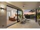 View from patio into main bedroom showcasing luxurious king bed and desert views at sunset at 9022 E Diamond Rim Dr, Scottsdale, AZ 85255