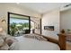 This main bedroom features a fireplace with a patio view at 9022 E Diamond Rim Dr, Scottsdale, AZ 85255