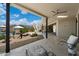 Charming outdoor patio with comfortable seating, a ceiling fan, and scenic views of the pool and surrounding landscape at 9022 E Diamond Rim Dr, Scottsdale, AZ 85255