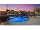 Inviting pool and spa with underwater lighting, surrounded by desert landscaping for ultimate privacy at 9022 E Diamond Rim Dr, Scottsdale, AZ 85255