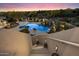 View down the stairway to the custom pool and spa with rock waterfall feature and desert landscaping at 9022 E Diamond Rim Dr, Scottsdale, AZ 85255