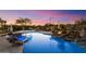 Gorgeous pool and spa featuring desert landscaping, rock features, lounge chairs, and mountain views at 9022 E Diamond Rim Dr, Scottsdale, AZ 85255