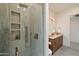 Stylish bathroom showcases tiled shower with built-in niche and modern fixtures next to vanity at 9022 E Diamond Rim Dr, Scottsdale, AZ 85255