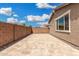 A backyard features an expansive stone patio with ample space for outdoor seating and entertaining at 10352 E Sebring Ave, Mesa, AZ 85212