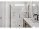 Bright bathroom featuring a glass enclosed shower with shelves, a white countertop and black faucet at 10352 E Sebring Ave, Mesa, AZ 85212