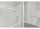 Clean bathroom features a shower-tub combo with white tiling and stylish grey flooring at 10352 E Sebring Ave, Mesa, AZ 85212