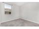Neutral bedroom with a window providing natural light and plush carpeting with white trim at 10352 E Sebring Ave, Mesa, AZ 85212