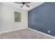 Comfortable bedroom with modern ceiling fan and a striking accent wall at 10352 E Sebring Ave, Mesa, AZ 85212