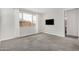 Bright bedroom with a large window offering natural light and plush carpet flooring at 10352 E Sebring Ave, Mesa, AZ 85212