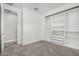 Spacious bedroom with plush carpet, a built-in closet, and an entrance to another room at 10352 E Sebring Ave, Mesa, AZ 85212