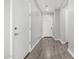 Light, modern hallway featuring gray wood-look floors and white doors with brushed fixtures at 10352 E Sebring Ave, Mesa, AZ 85212