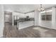 Modern kitchen with white cabinets, granite countertops, and stainless steel appliances open to the living area at 10352 E Sebring Ave, Mesa, AZ 85212