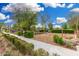 A landscaped walkway leads to a playground and picnic area, surrounded by well-maintained greenery at 10352 E Sebring Ave, Mesa, AZ 85212